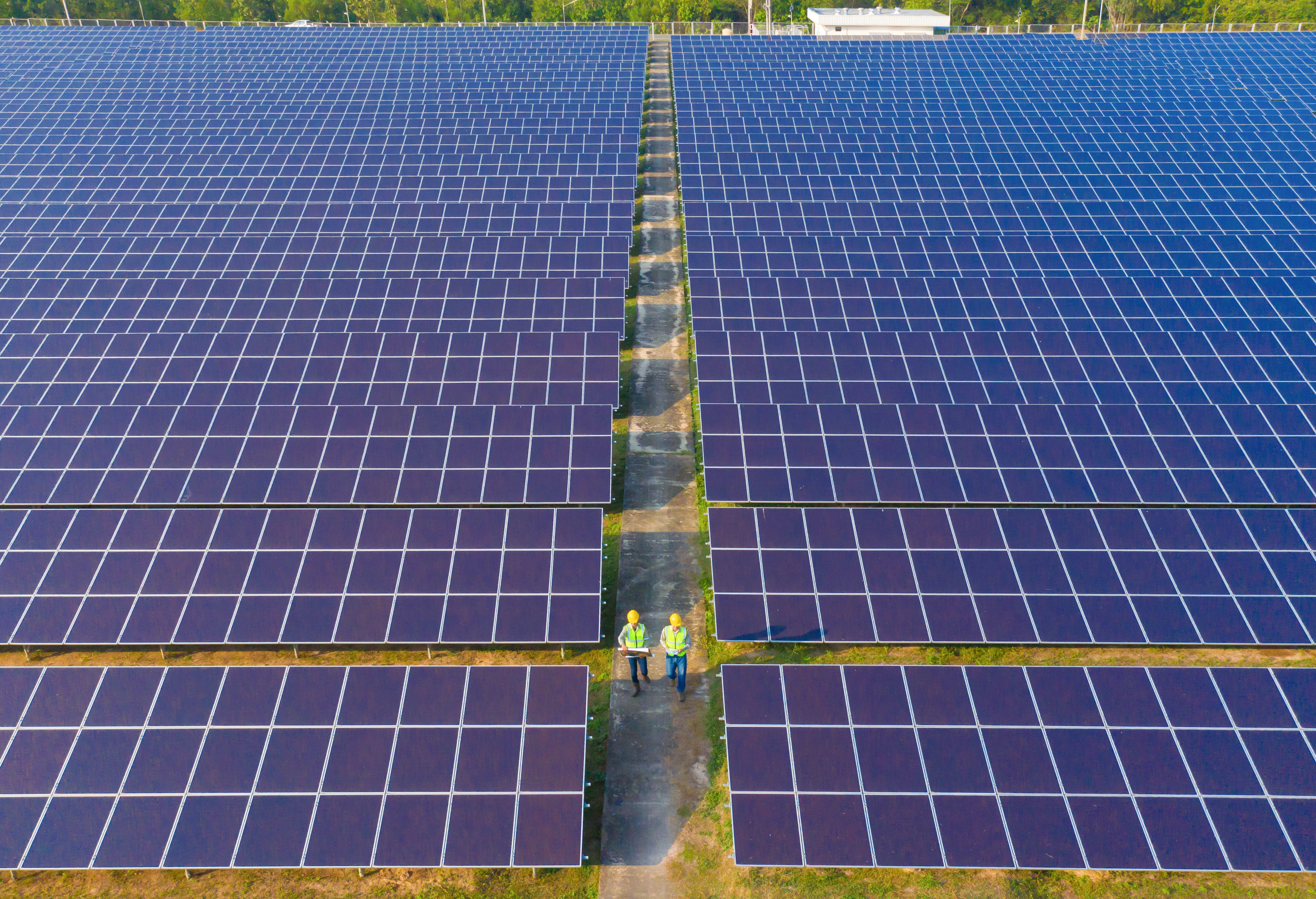 Utility‑scale solar with battery yard at sunset